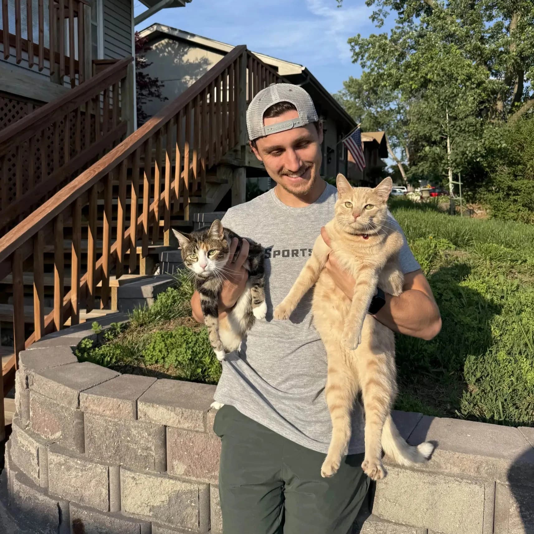 Jakob at home with his two cats
